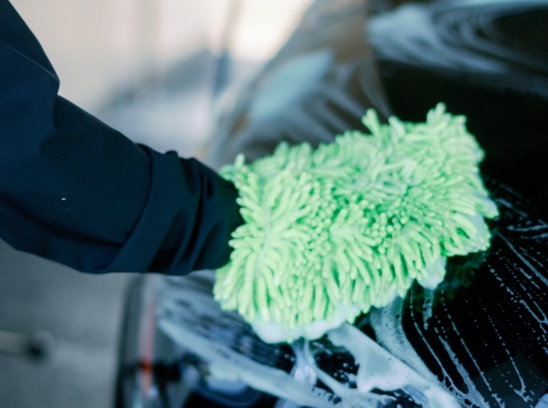 car-wash-39 Hand washing a car using a green sponge glove during an exterior detail